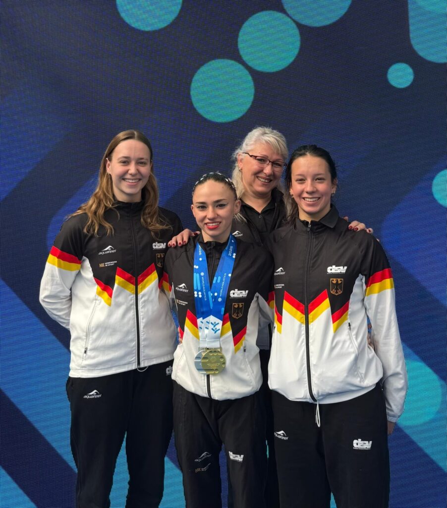 Gruppenfoto der deutschen Synchronschwimmerinnen Maria Denisov, Klara Bleyer und Amélie Blumenthal Haz mit ihrer Trainerin Stella Mukhamedova beim Weltcup 2026 in Paris